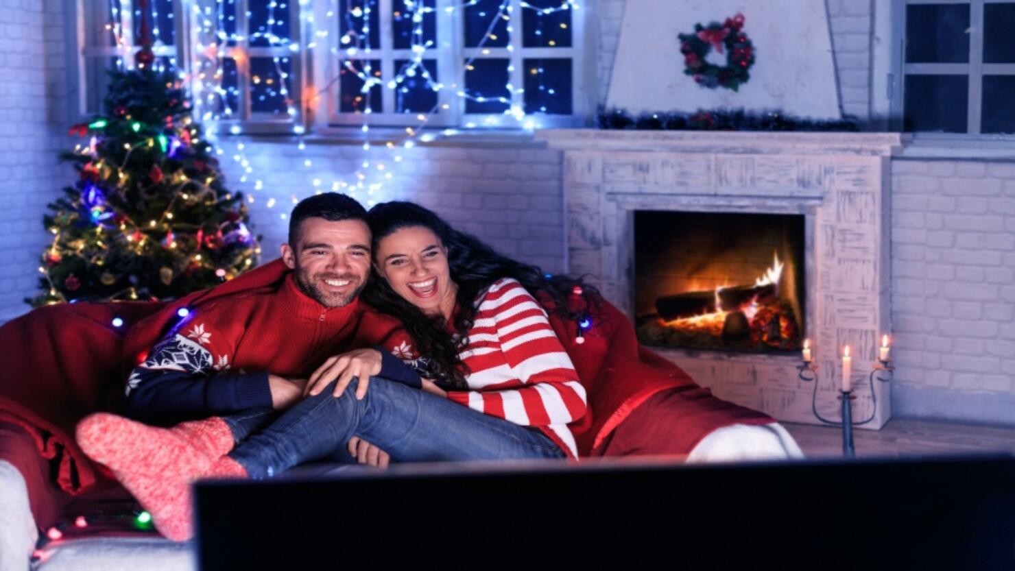 Couple watching TV at home