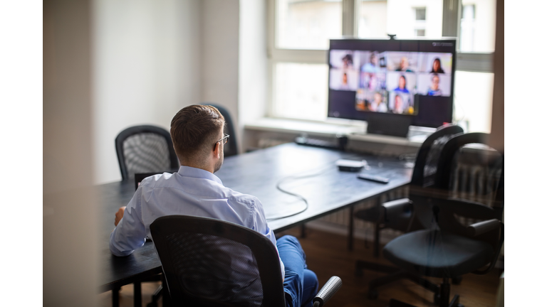 Businessman having a meeting with his team over a video call