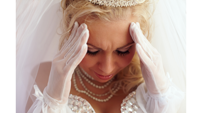 close-up portrait of beautiful bride frowned on troubles. white background