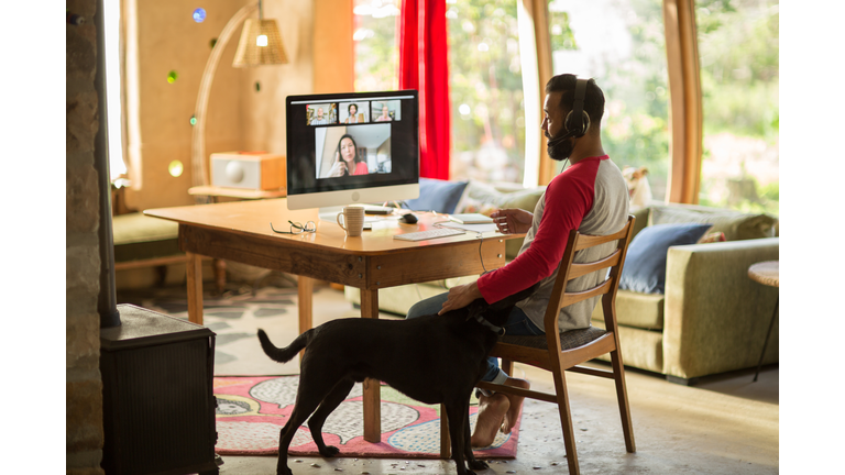 Mixed race man working from home on his computer during lockdown