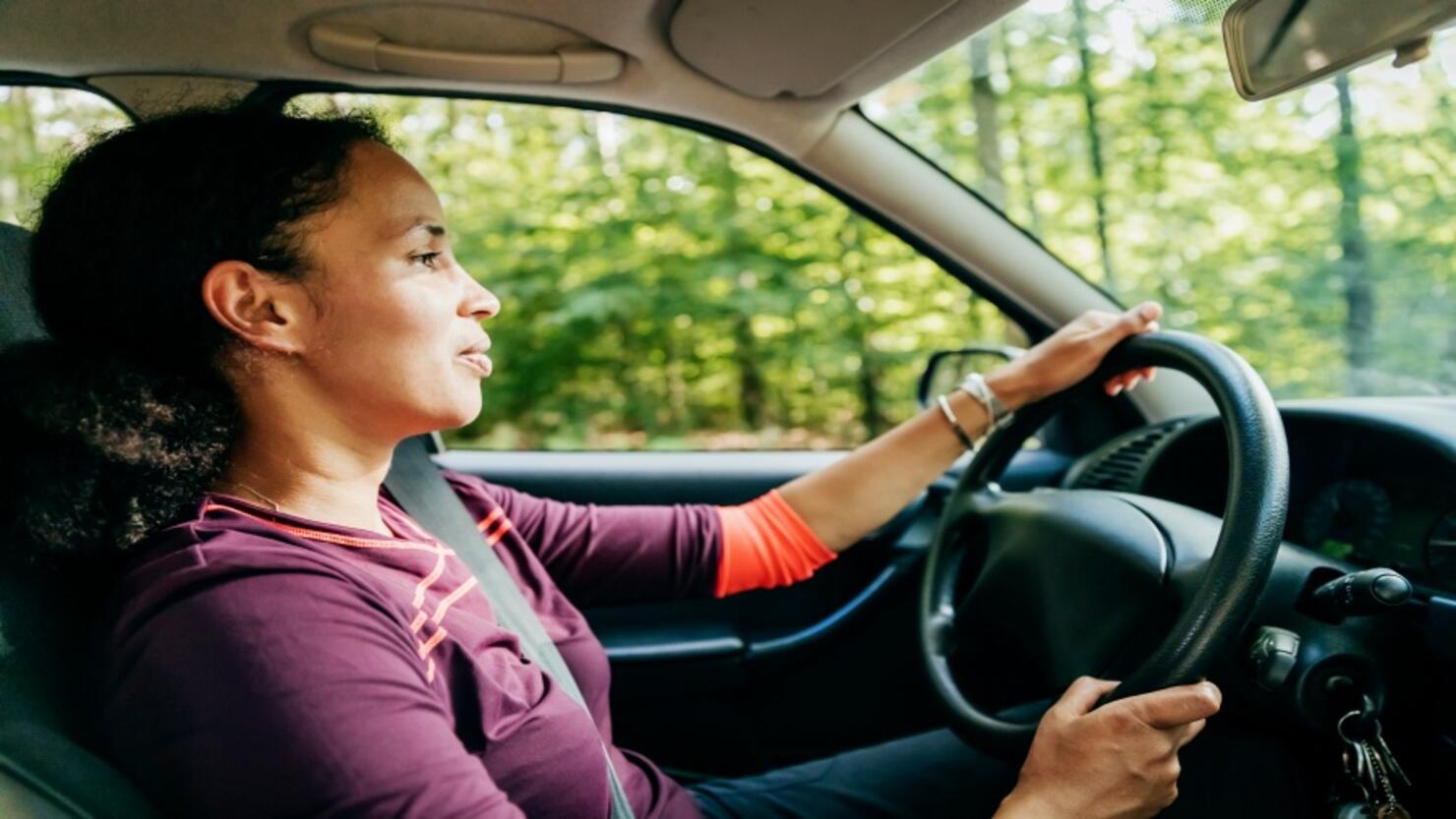 Mother Driving Home After Hiking With Sons