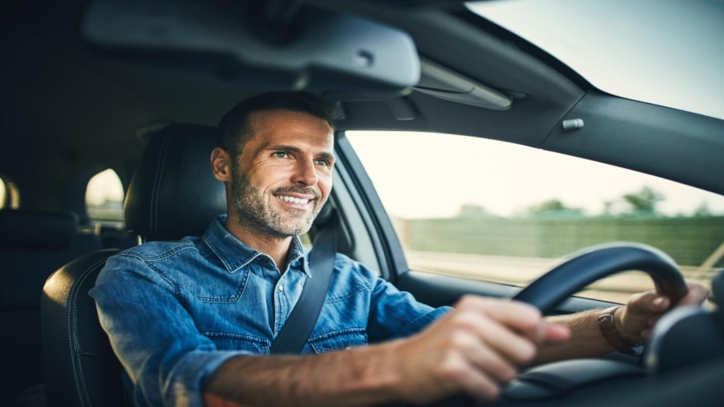 Handsome man driving a car