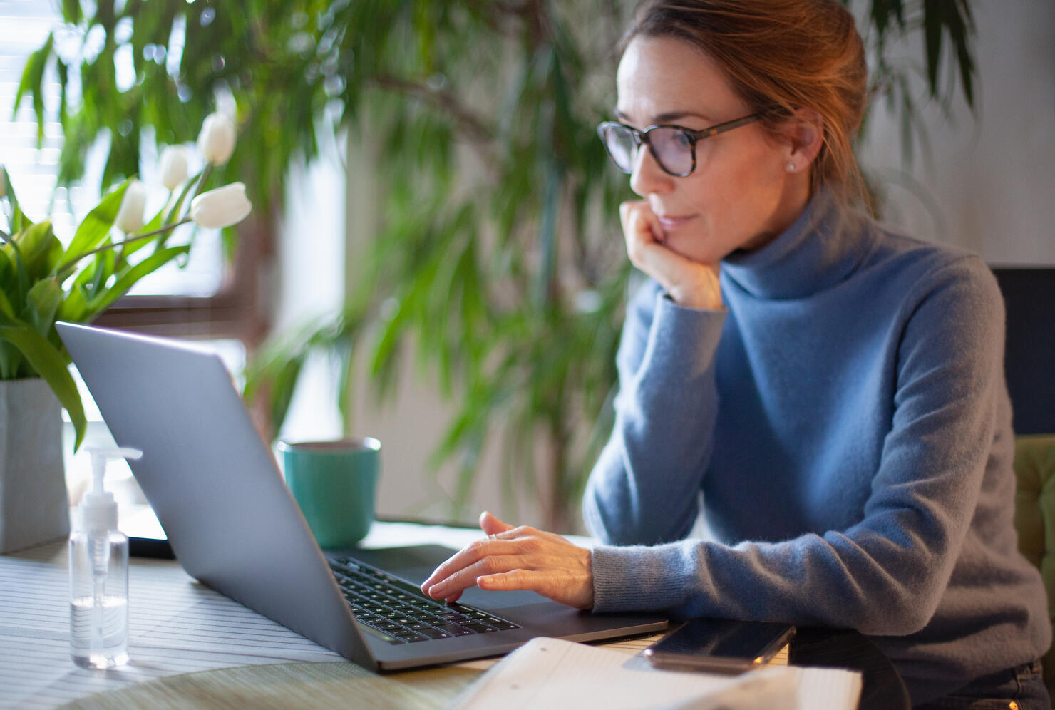 Woman working from home using laptop computer