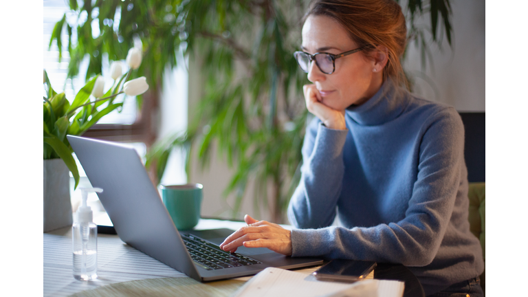 Woman working from home using laptop computer