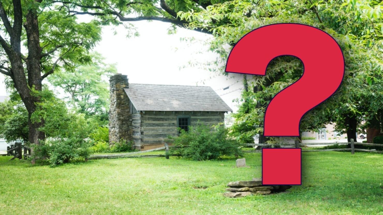 Old log schoolhouse in grass