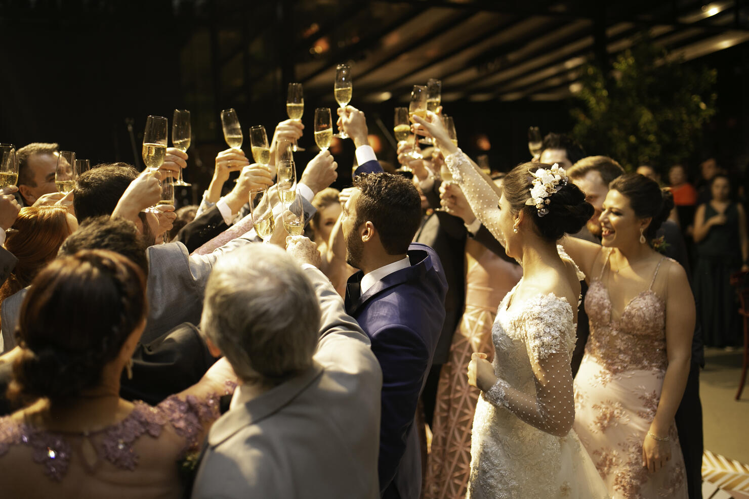 Bride, groom and wedding guests making a toast