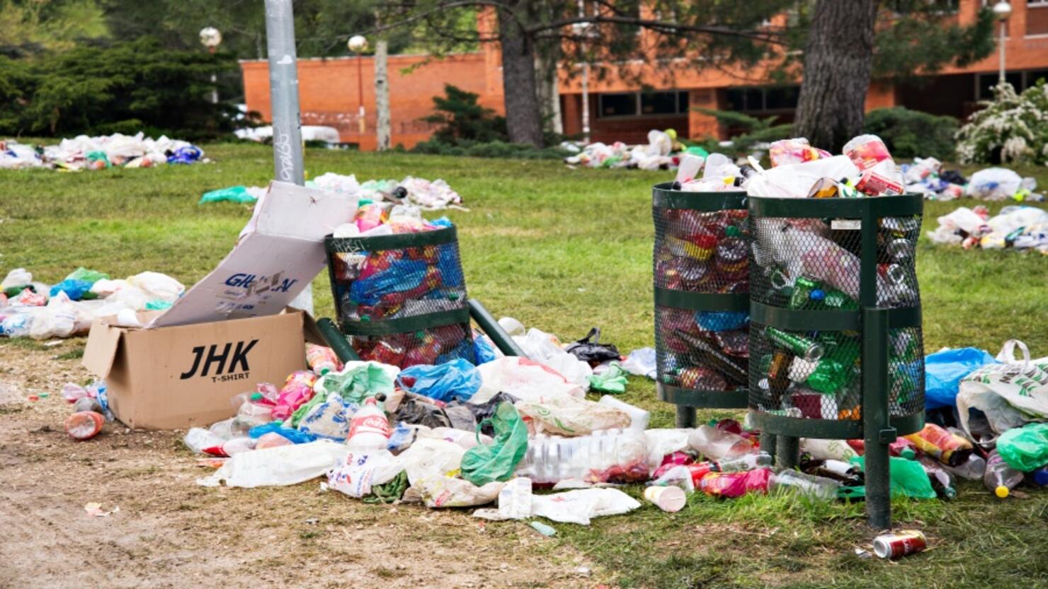 Overflowing bins in a park of Ciudad Universitaria, Madrid