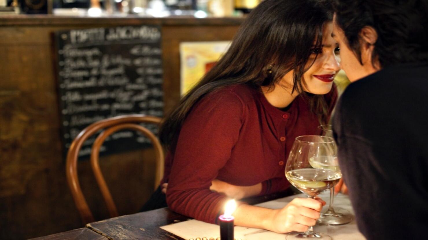 Young couple having a romantic moment at a restaurant, Rome, Italy