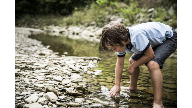 Boy exploring in stream