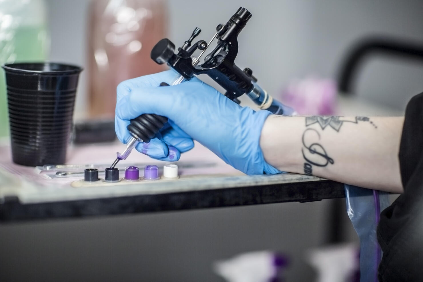 Tattoo artist in studio preparing