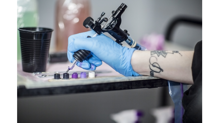 Tattoo artist in studio preparing