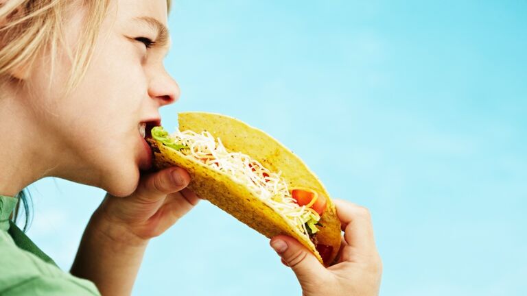 Boy eating taco