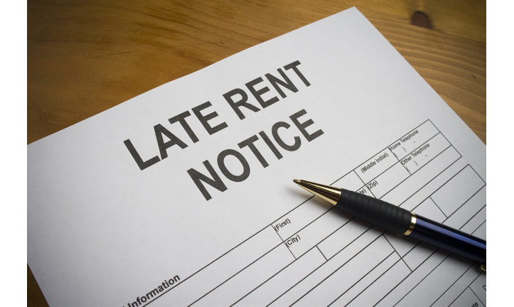 Late rent notice paperwork with pen