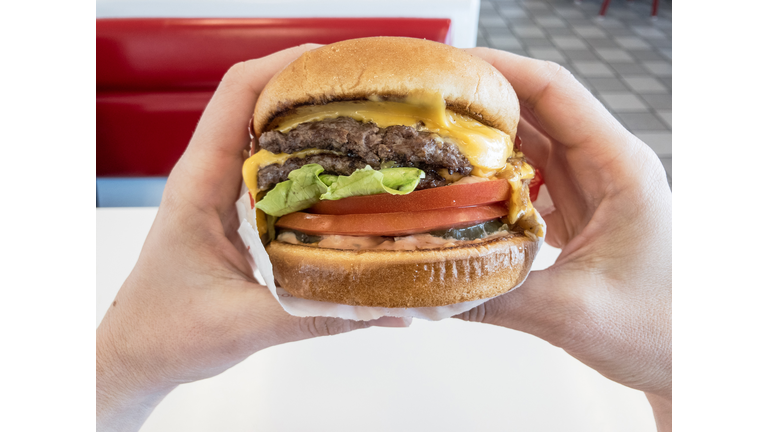 Close-Up Of Hand Holding Burger