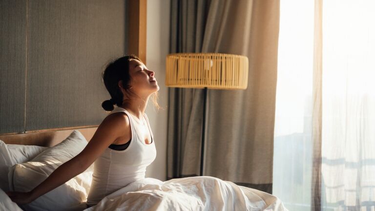Young Woman Waking Up To A Brand New Day