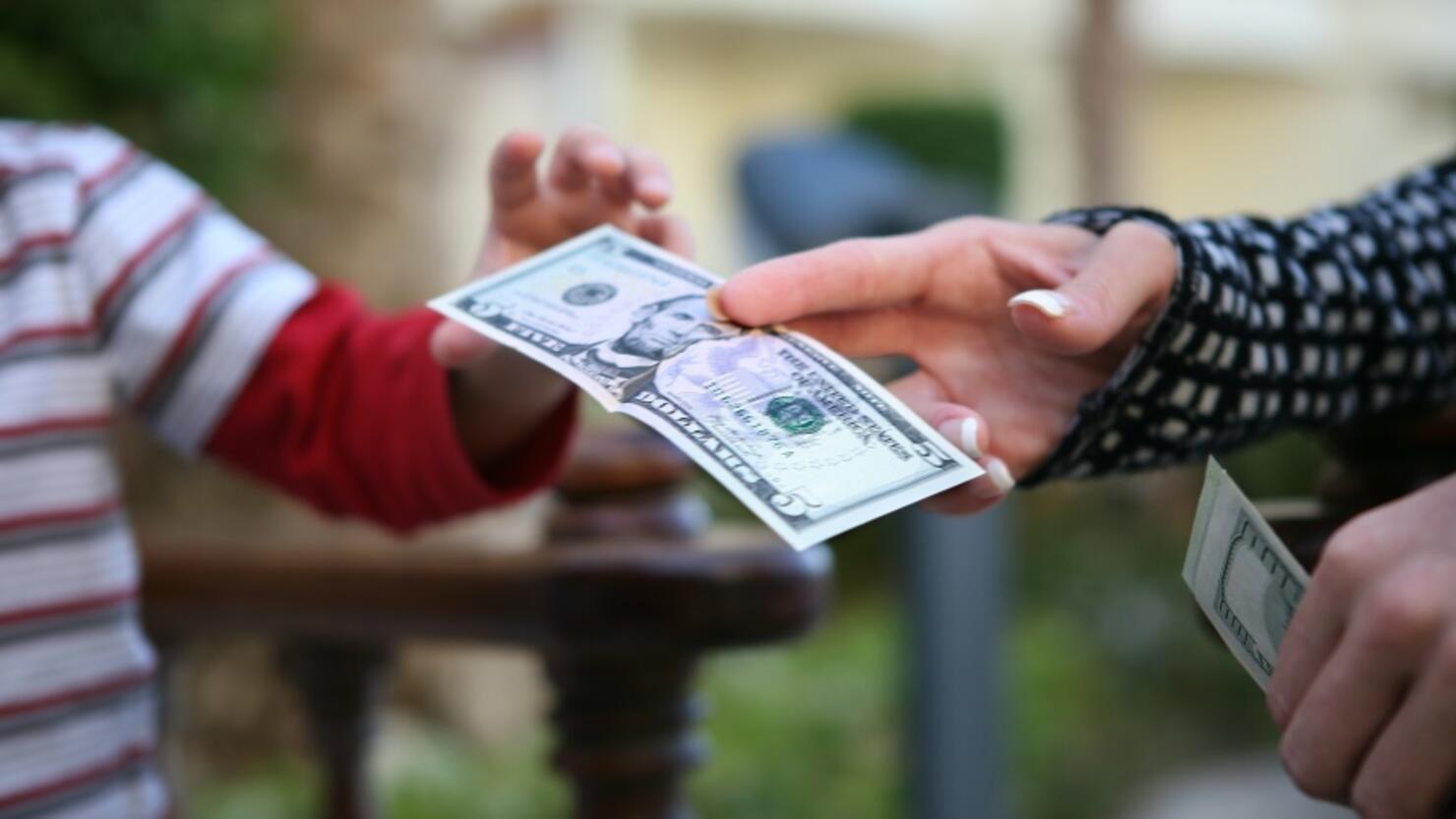 Cropped Hand Of Mother Giving Paper Currency To Son