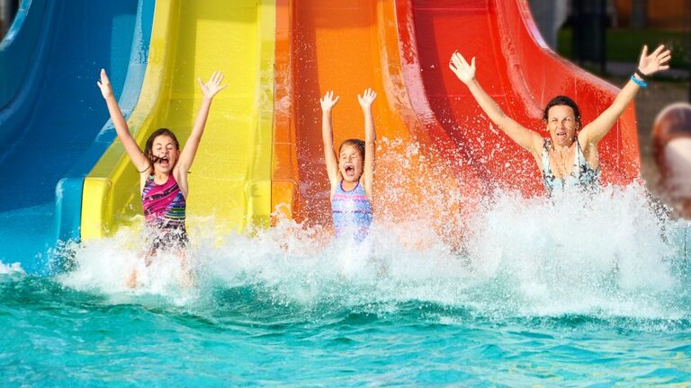 Family on water slide at aquapark, Romania.