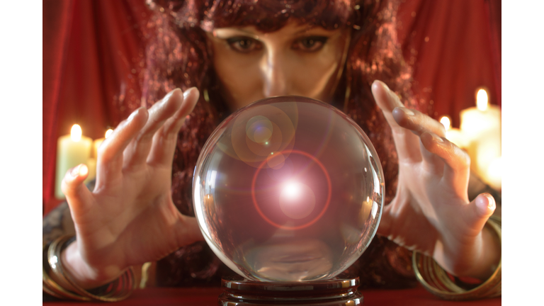 Fortune teller looking into crystal ball