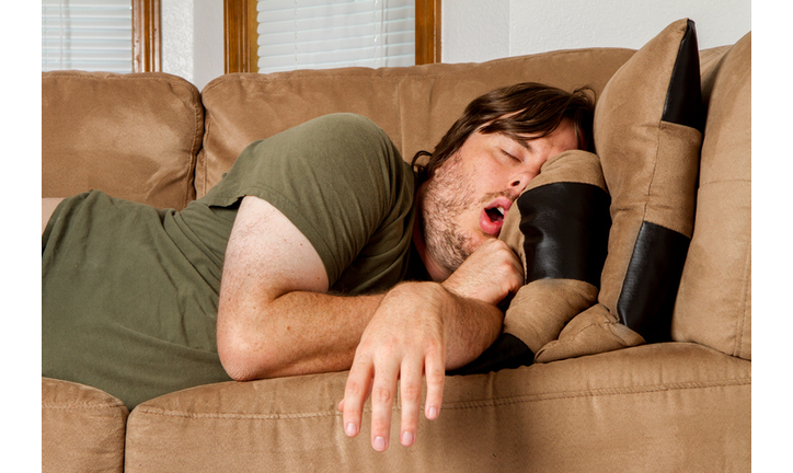 Man taking a quick nap on the couch