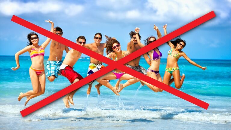 Happy group of young people jumping on a beach party