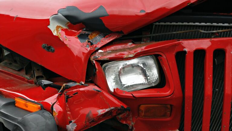Part of a red truck crushed in an accident