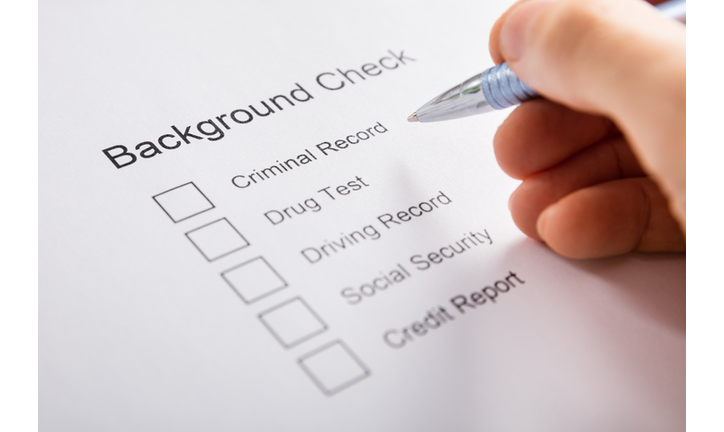 Person Hand Filling Background Check Form