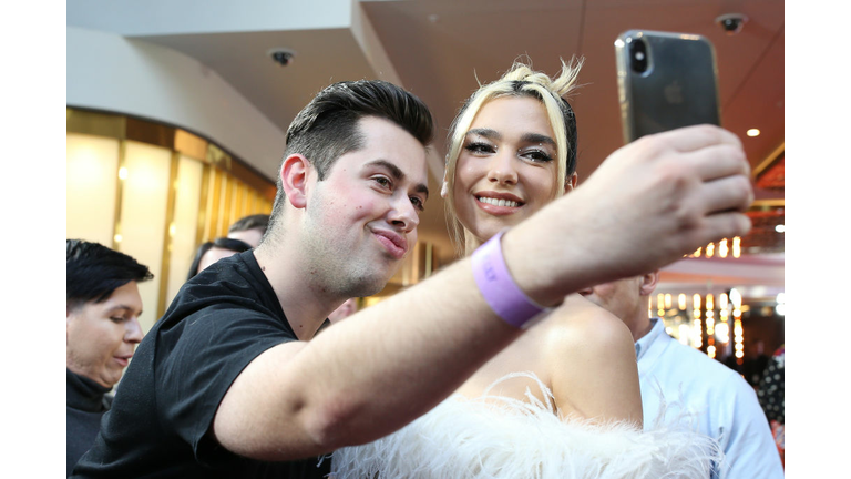 Dua Lipa poses for selfie with fan at an award show