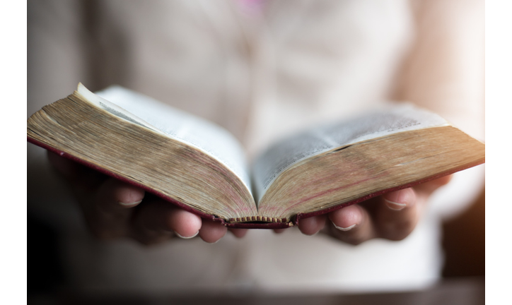 Woman reading holy bible.