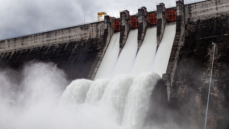 Water flowing over floodgates of a dam at Khun Dan Prakan Chon.