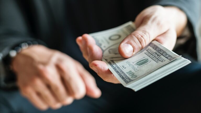 Closeup of hands holding cash
