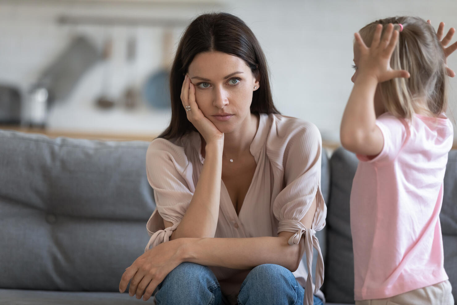 Unhappy mother having problem with noisy naughty little daughter