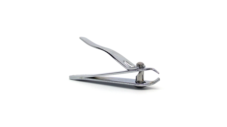 Close-Up Of Nail Clippers Against White Background