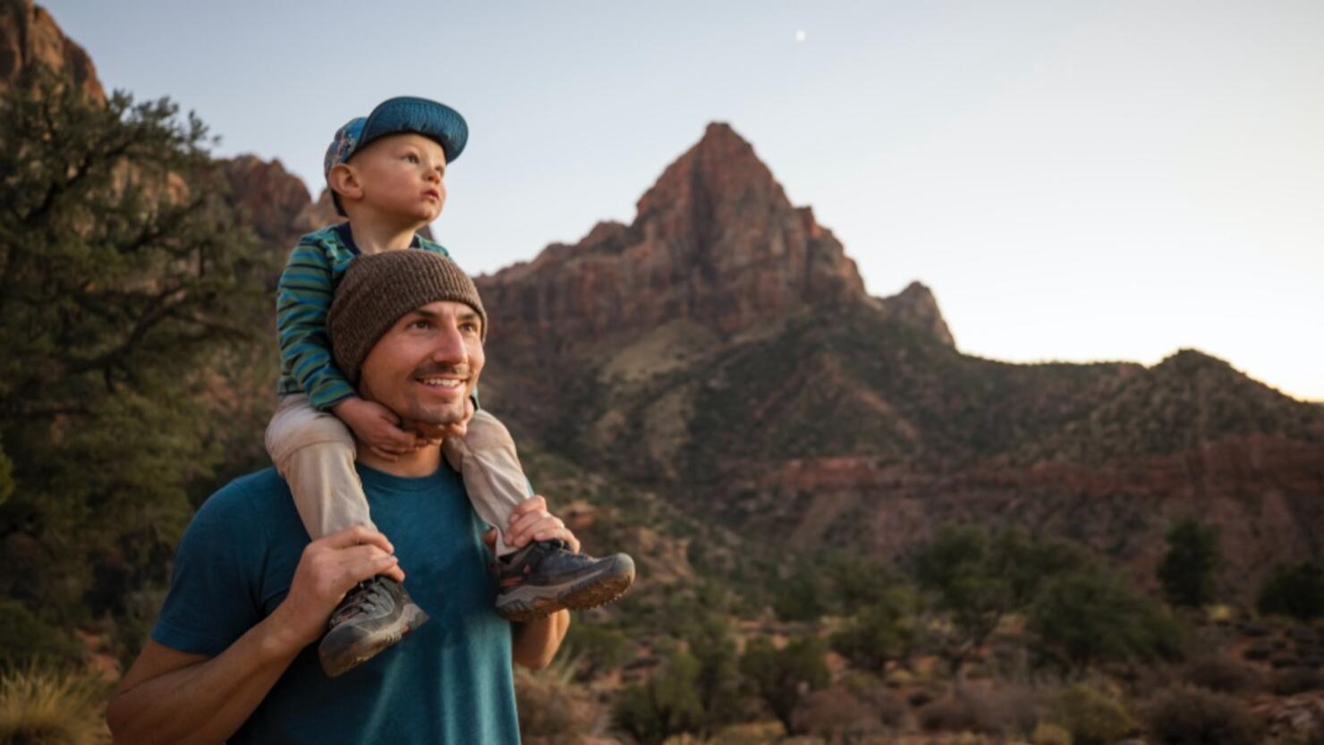 A father and his son hiking a scenic trail