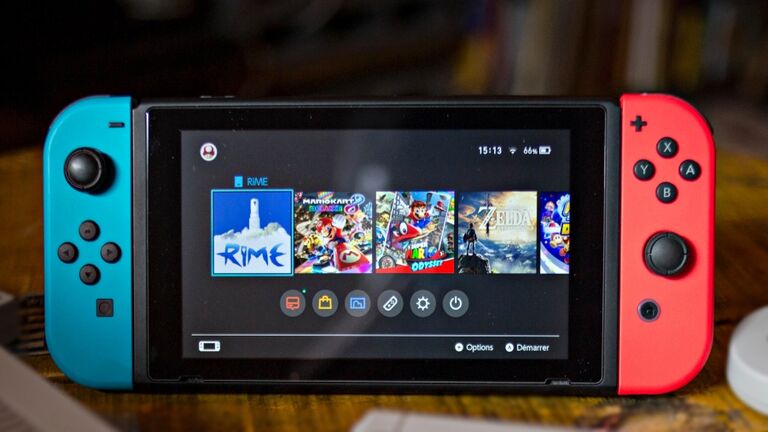 A Nintendo Switch (M) surrounded by a NES (Nintendo