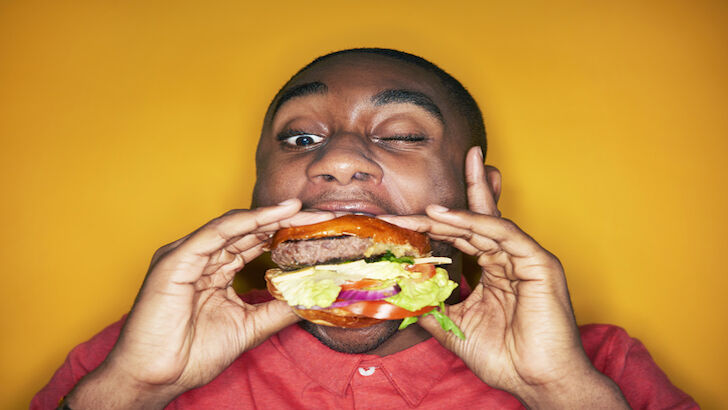man eating hamburger
