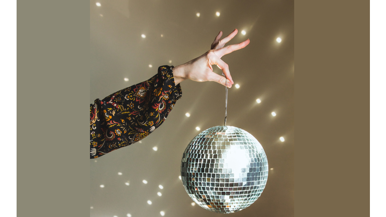 Hand Holding Disco Ball Retro 1970s