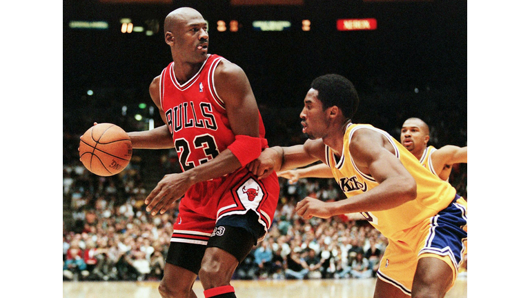 Michael Jordan of the Chicago Bulls (L) eyes the b