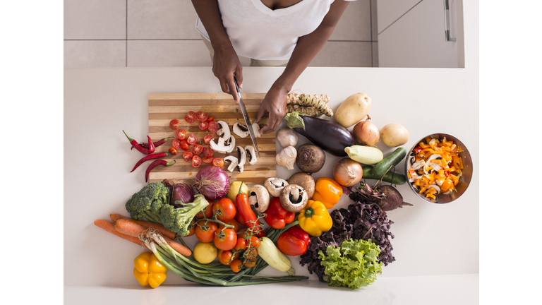 Unrecognized women preparing fresh healthy salad.