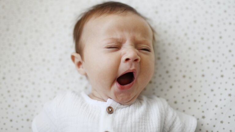 A 4 month old baby girl yawning