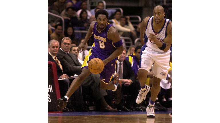 Kobe Bryant of the Los Angeles Lakers (L) starts a