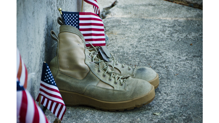 Close-Up Of Shoes With American Flags On Footpath