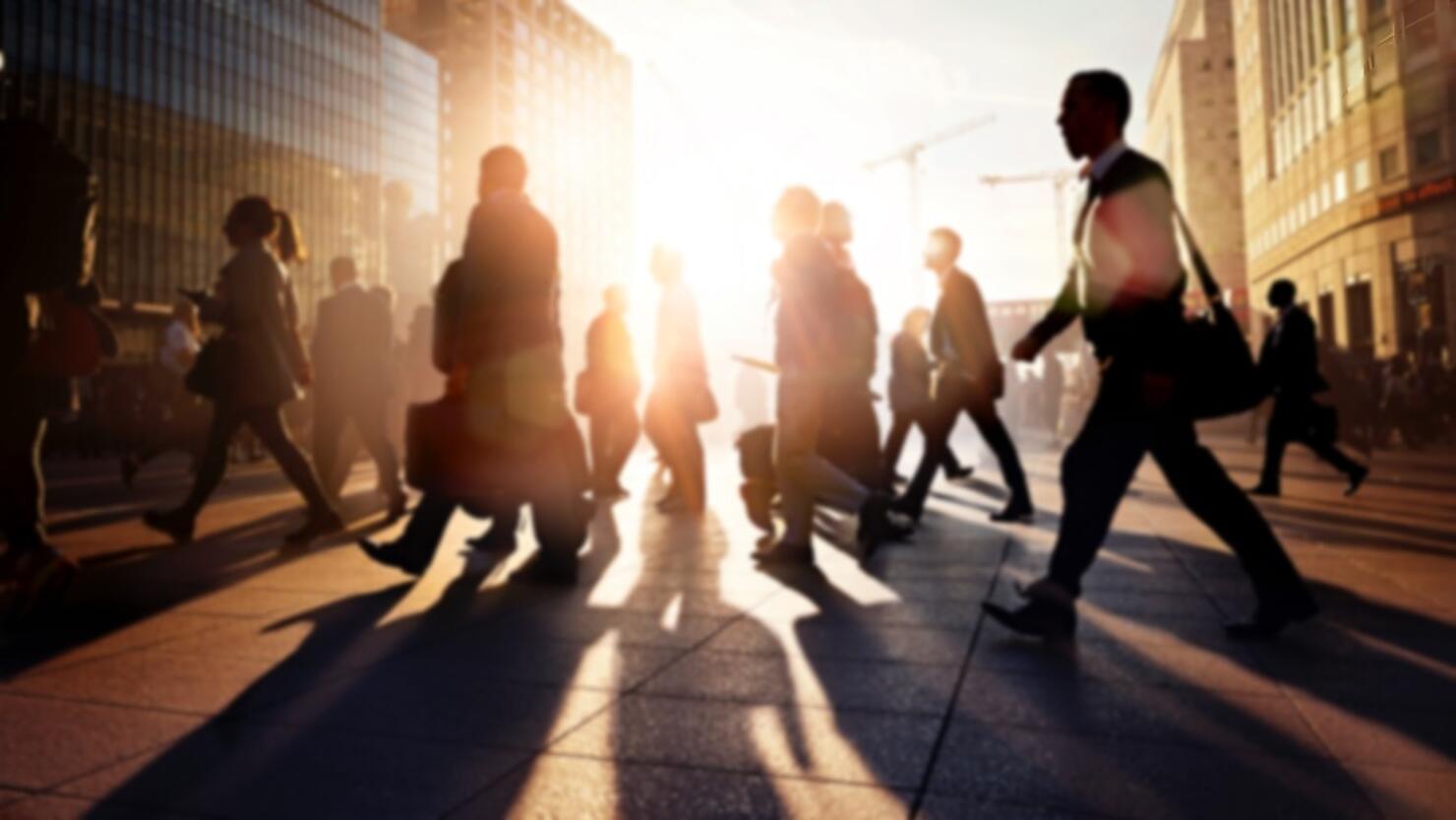 Employees walking to work in the city at sunrise
