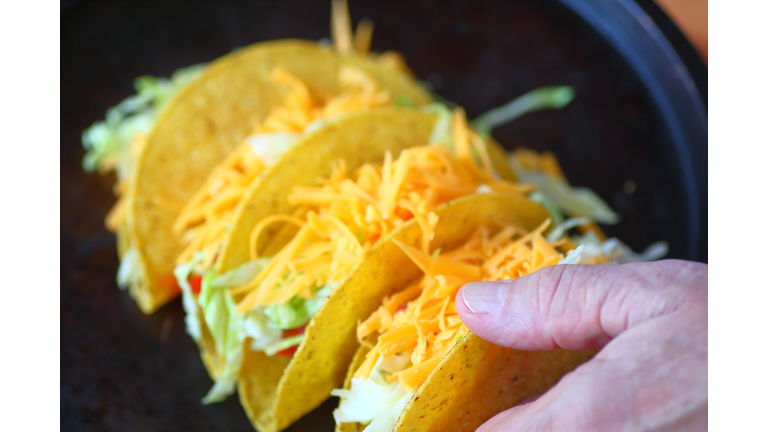 Cropped Hand Of Person Holding Tacos