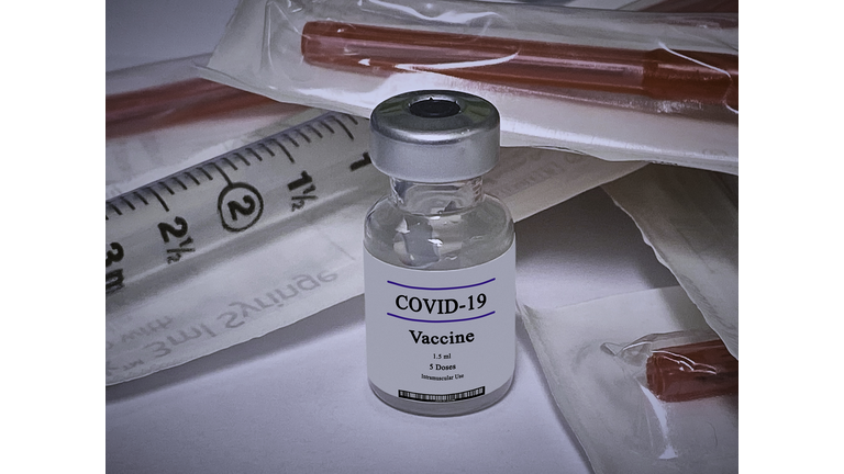Close-up of COVID-19 Vaccine with syringes in medical environment