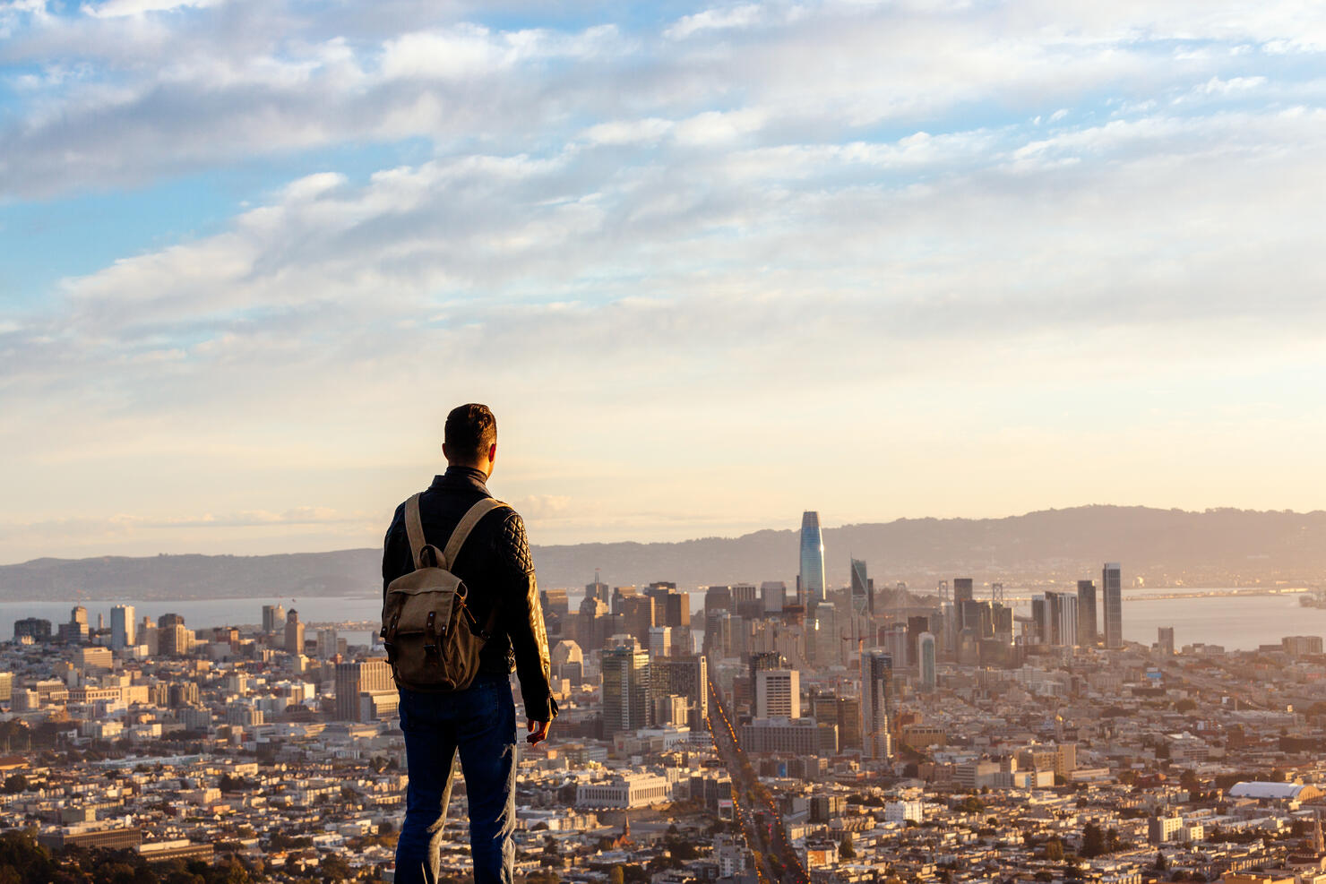 Man overlooking San Francisco skyline from above during sunrise, San Francisco, California, USA