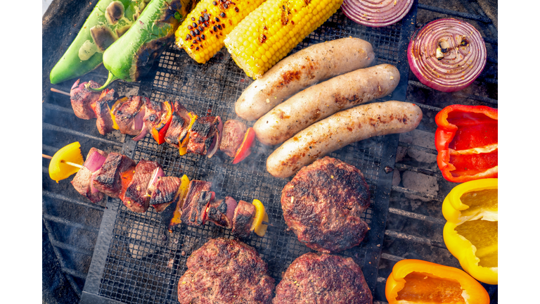 A Beautiful Mixed Grill Meat And Fresh Vegetables Arranged On A Charcoal Grill