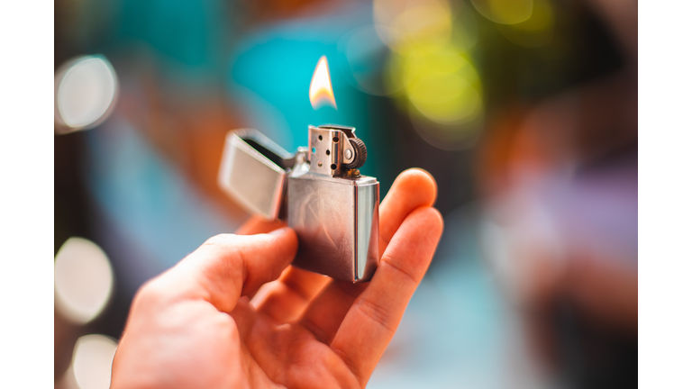 Close-Up Of Hand Holding Burning Lighter