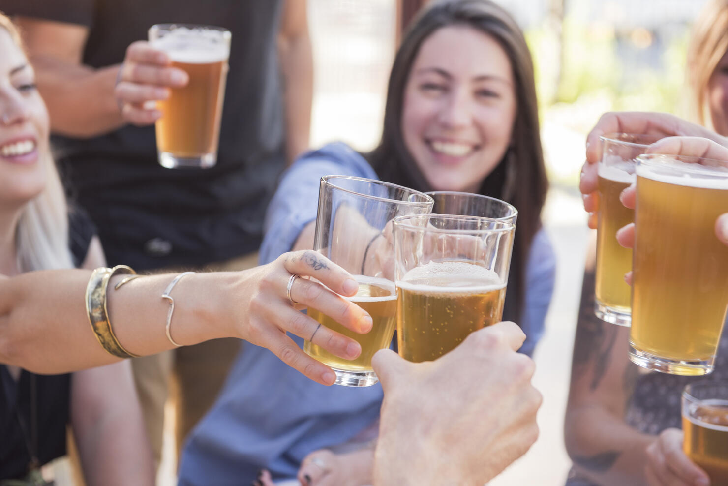 Happy friends toasting with beer
