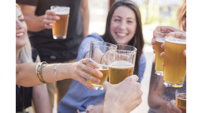 Happy friends toasting with beer