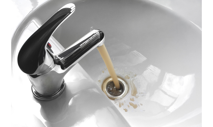 Water Tap With Running Dirty Muddy Water in a Sink